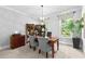 A home office features a wooden desk, upholstered chairs, decorative screen, and a bright window view at 140 Discovery Lake Dr, Fayetteville, GA 30215