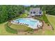 Community pool with lounge chairs surrounded by a fence and lush greenery at 140 Discovery Lake Dr, Fayetteville, GA 30215