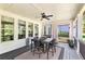 Charming screened porch with outdoor furniture, ceiling fan, and wooded backyard views at 140 Discovery Lake Dr, Fayetteville, GA 30215