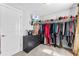 Spacious walk-in closet with custom shelving, dresser, and ample storage for clothes and accessories at 140 Discovery Lake Dr, Fayetteville, GA 30215