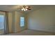 Bedroom with a ceiling fan, neutral carpet, and a large window with blinds at 2004 Burns View Ln, Lawrenceville, GA 30044