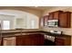 Kitchen featuring stainless steel appliances and an open view to the living room at 2004 Burns View Ln, Lawrenceville, GA 30044