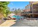 Expansive backyard with a pool, spa, covered patio, and lush landscaping at 2805 Cambria Ct, Cumming, GA 30041