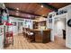 Entertaining bar boasts wood counters, seating, wood ceiling with dark beams and a vintage popcorn machine at 2805 Cambria Ct, Cumming, GA 30041