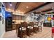 Finished basement bar area with custom wood cabinets, a beverage fridge, and barstool seating at 2805 Cambria Ct, Cumming, GA 30041