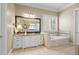Bright bathroom with a jetted tub, white cabinets, and granite countertops at 2805 Cambria Ct, Cumming, GA 30041