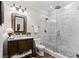 Bright bathroom with a walk-in shower, vanity with dark wood cabinets and brushed nickel fixtures at 2805 Cambria Ct, Cumming, GA 30041