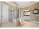 Bright bathroom featuring a glass shower, granite countertop, tiled floor, and vanity with ample cabinet space at 2805 Cambria Ct, Cumming, GA 30041