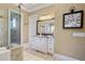 Bright bathroom featuring a glass shower, granite countertop, tiled floor, and vanity with ample cabinet space at 2805 Cambria Ct, Cumming, GA 30041