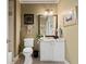 Cozy bathroom featuring a white single sink vanity and framed mirror at 2805 Cambria Ct, Cumming, GA 30041