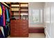 Custom closet featuring built-in storage and drawers, plus a window seat offering natural light at 2805 Cambria Ct, Cumming, GA 30041