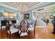Stylish dining area featuring a modern chandelier, designer paint, hardwood floors, and refined decor at 2805 Cambria Ct, Cumming, GA 30041