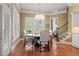 Bright dining room with a chandelier, hardwood floors, and large windows with shutter-style blinds at 2805 Cambria Ct, Cumming, GA 30041