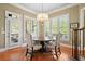 Dining area featuring hardwood floors, natural light from the windows, and a chandelier at 2805 Cambria Ct, Cumming, GA 30041