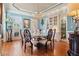 Formal dining room with elegant chandelier, custom built-ins, hardwood floors, and refined decor at 2805 Cambria Ct, Cumming, GA 30041