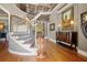 Grand foyer features a curved staircase with iron railings and hardwood floors at 2805 Cambria Ct, Cumming, GA 30041