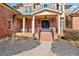 Charming home entrance with a brick facade, a covered porch, and professionally landscaped front yard at 2805 Cambria Ct, Cumming, GA 30041
