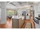 Bright kitchen featuring a large island with a farmhouse sink, stainless steel appliances, and modern white cabinetry at 2805 Cambria Ct, Cumming, GA 30041