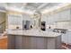 Spacious kitchen with a large island featuring granite countertops, a sink, stainless appliances, and white cabinetry at 2805 Cambria Ct, Cumming, GA 30041