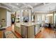 Open-concept kitchen featuring a large island with a farmhouse sink and views to the living and dining area at 2805 Cambria Ct, Cumming, GA 30041