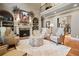 Cozy living room with a fireplace, built-in shelving, and plush seating at 2805 Cambria Ct, Cumming, GA 30041