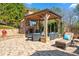 Inviting outdoor living space with a stone fireplace, television, and comfortable seating at 2805 Cambria Ct, Cumming, GA 30041