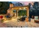 Covered outdoor living space with stone fireplace, TV, lighting, and comfortable seating at 2805 Cambria Ct, Cumming, GA 30041