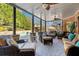 Covered outdoor living area with comfortable seating, overlooking the pool and lush landscaping at 2805 Cambria Ct, Cumming, GA 30041