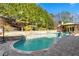 Inviting pool area featuring a stone deck, lush landscaping, and a cozy gazebo at 2805 Cambria Ct, Cumming, GA 30041