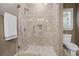 Modern shower with glass door, tiled walls, and decorative accents at 2805 Cambria Ct, Cumming, GA 30041