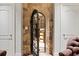 Ornate metal door leading to the wine cellar with stone archway at 2805 Cambria Ct, Cumming, GA 30041