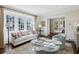 Sunlit living room featuring large windows, fireplace, and plush seating at 3114 Peachtree Ne Dr, Atlanta, GA 30305