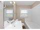Bathroom featuring a white sink, tub, and window at 4251 Klondike Rd, Lithonia, GA 30038