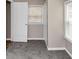 Bedroom featuring plush gray carpeting, a large window with blinds, and a closet for ample storage space at 4251 Klondike Rd, Lithonia, GA 30038