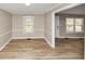Dining room with wood-look floors, neutral walls, and views of the outdoors through the windows at 4251 Klondike Rd, Lithonia, GA 30038