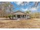 Charming single-story home with a covered front porch, gray siding, dark shutters, and a well-maintained lawn at 4251 Klondike Rd, Lithonia, GA 30038