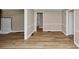 Open-concept living space showcasing wood-look floors, neutral paint, and seamless flow into other areas at 4251 Klondike Rd, Lithonia, GA 30038