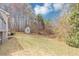 Large grassy yard featuring a shed and tree line. The perfect backyard for your new home! at 4251 Klondike Rd, Lithonia, GA 30038