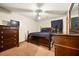 Bedroom features a ceiling fan, dark wood furniture, carpet and a bed with dark sheets at 7281 Fernwood Dr, Riverdale, GA 30296