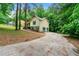Lovely home with attached garage and long driveway through wooded area at 7281 Fernwood Dr, Riverdale, GA 30296