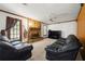 Spacious living room with stone fireplace and lots of natural light at 7281 Fernwood Dr, Riverdale, GA 30296