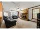 Cozy living room featuring a stone fireplace and large windows at 7281 Fernwood Dr, Riverdale, GA 30296