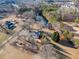 Expansive aerial view of a house on a large lot bordering a river with mature trees and surrounding neighborhood at H-5422 Hill Sw Rd, Powder Springs, GA 30127