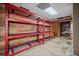 Basement with wooden walls, red shelving and exposed pipes at H-5422 Hill Sw Rd, Powder Springs, GA 30127