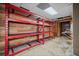 Unfinished basement with wood paneled walls and heavy duty shelving for storage at H-5422 Hill Sw Rd, Powder Springs, GA 30127