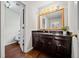 Bathroom featuring a dark vanity and a large framed mirror with a sink at H-5422 Hill Sw Rd, Powder Springs, GA 30127