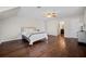Bedroom with hardwood floors, sloped ceiling, and a view into the bathroom at H-5422 Hill Sw Rd, Powder Springs, GA 30127