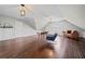Spacious bonus room with wood floors, sloped ceilings, and natural light at H-5422 Hill Sw Rd, Powder Springs, GA 30127
