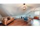Bonus room with sloped ceilings, wood floors, and warm lighting at H-5422 Hill Sw Rd, Powder Springs, GA 30127