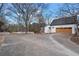 Extensive driveway leading to the home with ample parking and complemented by mature trees at H-5422 Hill Sw Rd, Powder Springs, GA 30127